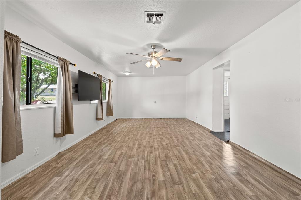304 Shepard Avenue Dundee, FL 33838 - Photo 19 of 62 wooden floor in an empty room with a window