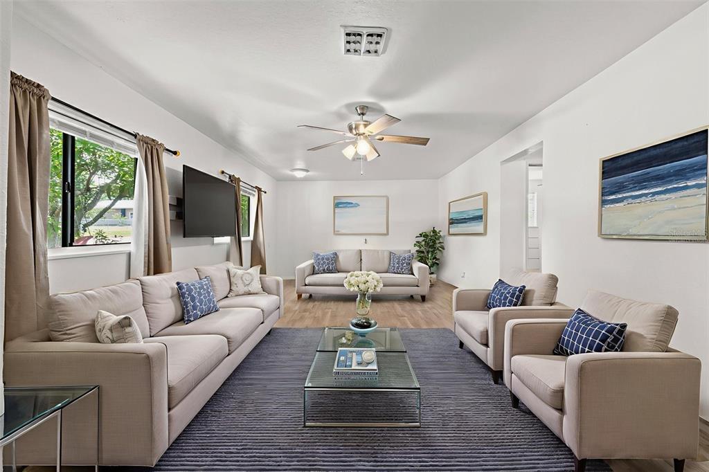 304 Shepard Avenue Dundee, FL 33838 - Photo 20 of 62 a living room with furniture fireplace and a large window