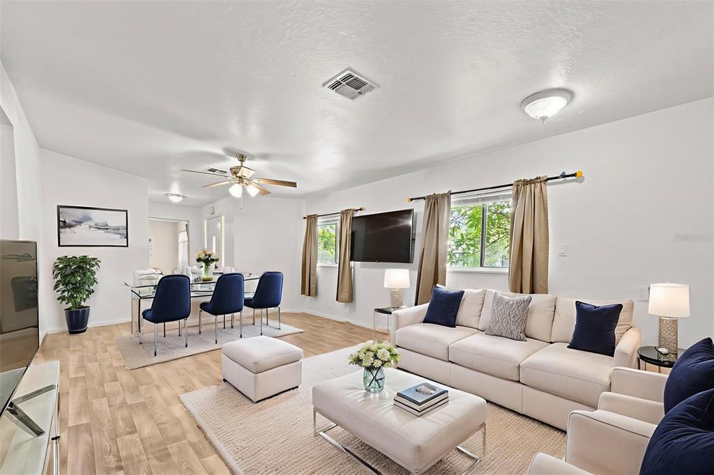 304 Shepard Avenue Dundee, FL 33838 - Photo 24 of 62 a living room with furniture flat screen tv and a large window