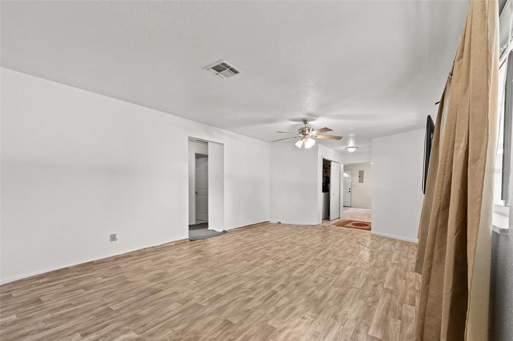 304 Shepard Avenue Dundee, FL 33838 - Photo 25 of 62 a view of a big room with wooden floor and a ceiling fan