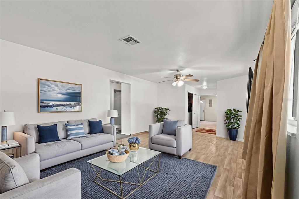 304 Shepard Avenue Dundee, FL 33838 - Photo 26 of 62 a living room with furniture and a chandelier