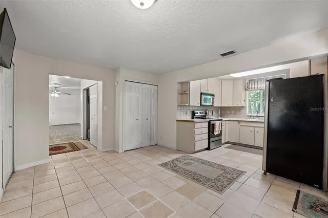 a bathroom with a granite countertop sink toilet a mirror a bathtub and shower