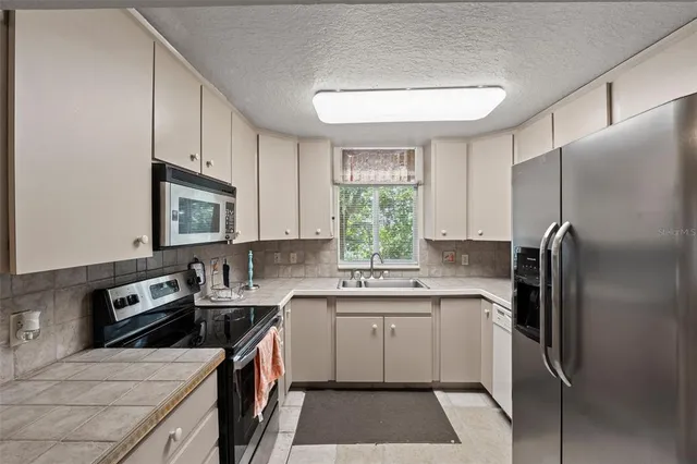 a bedroom with a bed dresser and a window