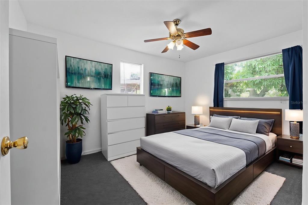 304 Shepard Avenue Dundee, FL 33838 - Photo 38 of 62 a bedroom with a bed and a flat screen tv