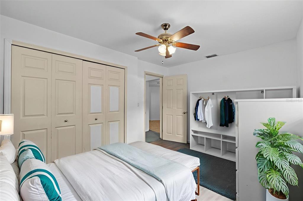 304 Shepard Avenue Dundee, FL 33838 - Photo 40 of 62 a bedroom with a bed and a chandelier