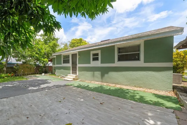 an aerial view of a house with a yard and lake view