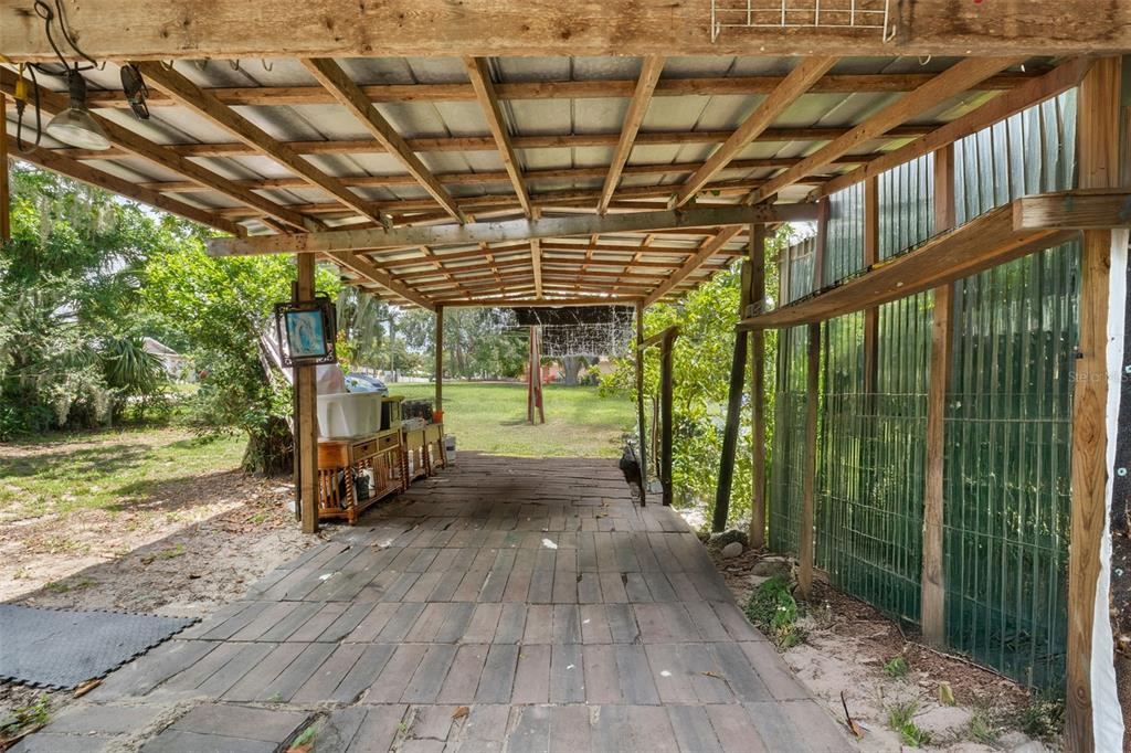 304 Shepard Avenue Dundee, FL 33838 - Photo 50 of 62 a view of a porch with a wooden deck