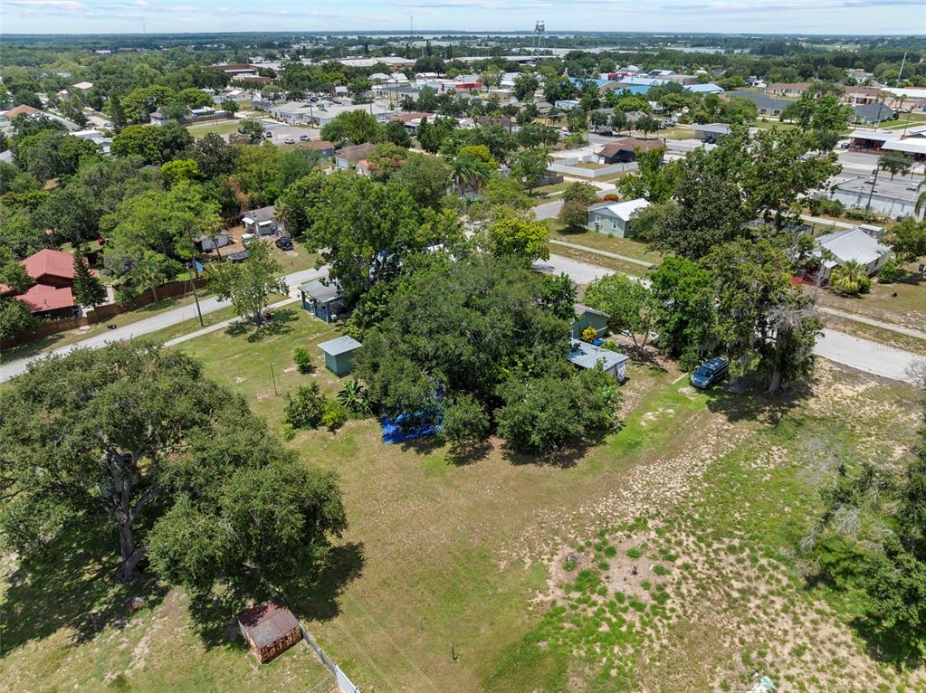 304 Shepard Avenue Dundee, FL 33838 - Photo 60 of 62 an aerial view of residential houses with outdoor space and trees
