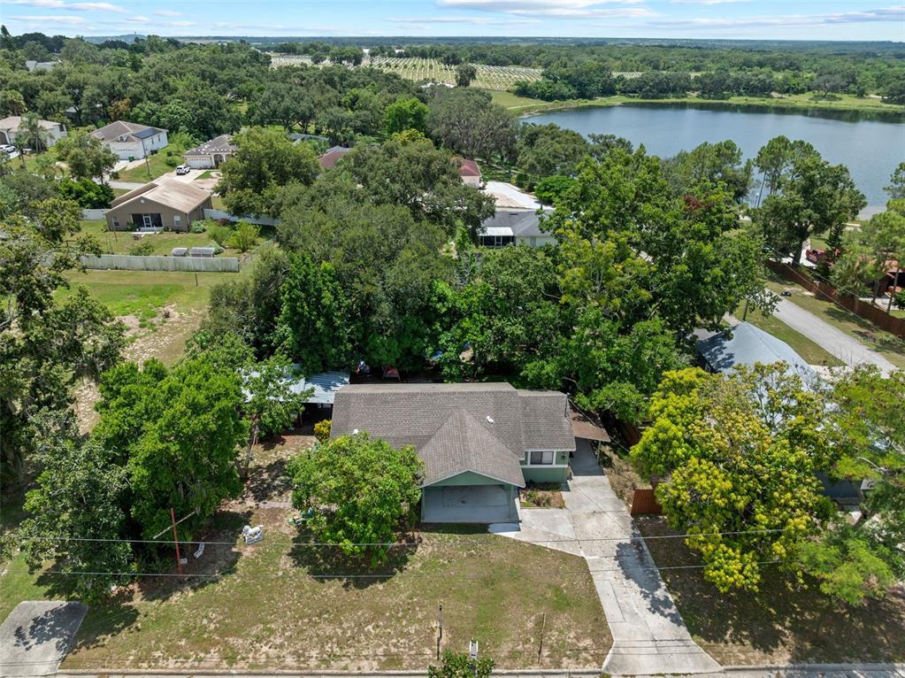 304 Shepard Avenue Dundee, FL 33838 - Photo 61 of 62 an aerial view of a house with a yard and lake view