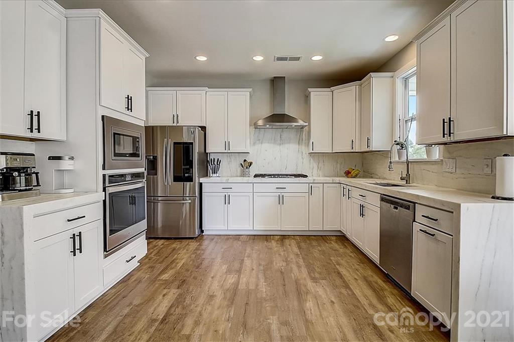 1217 Therns Ferry Drive Fort Mill, SC 29708 - Photo 15 of 47 a kitchen with white cabinets stainless steel appliances and sink