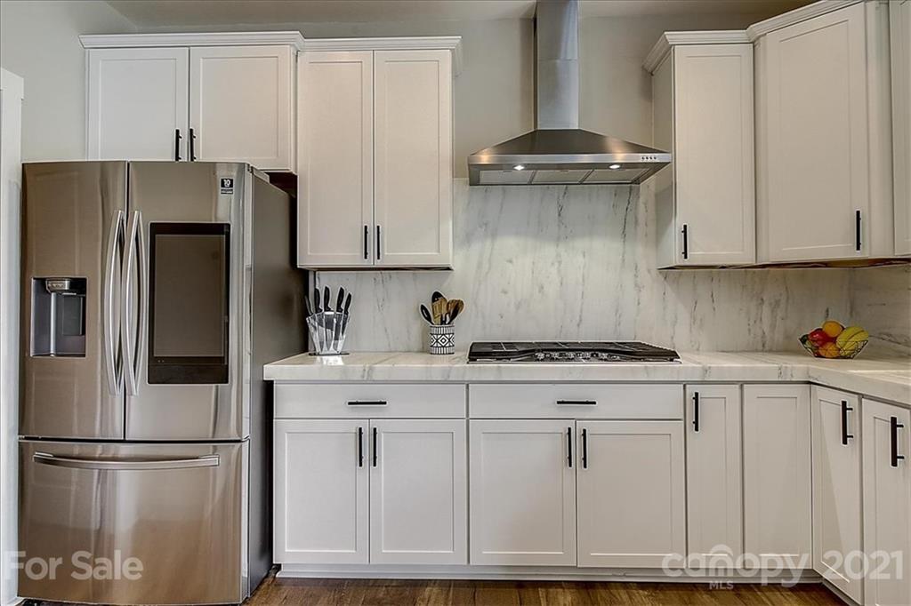 1217 Therns Ferry Drive Fort Mill, SC 29708 - Photo 16 of 47 a kitchen with stainless steel appliances granite countertop a refrigerator a stove a sink and white cabinets