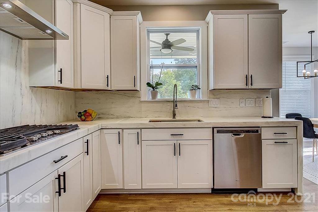 1217 Therns Ferry Drive Fort Mill, SC 29708 - Photo 18 of 47 a kitchen with stainless steel appliances granite countertop a sink stove and cabinets
