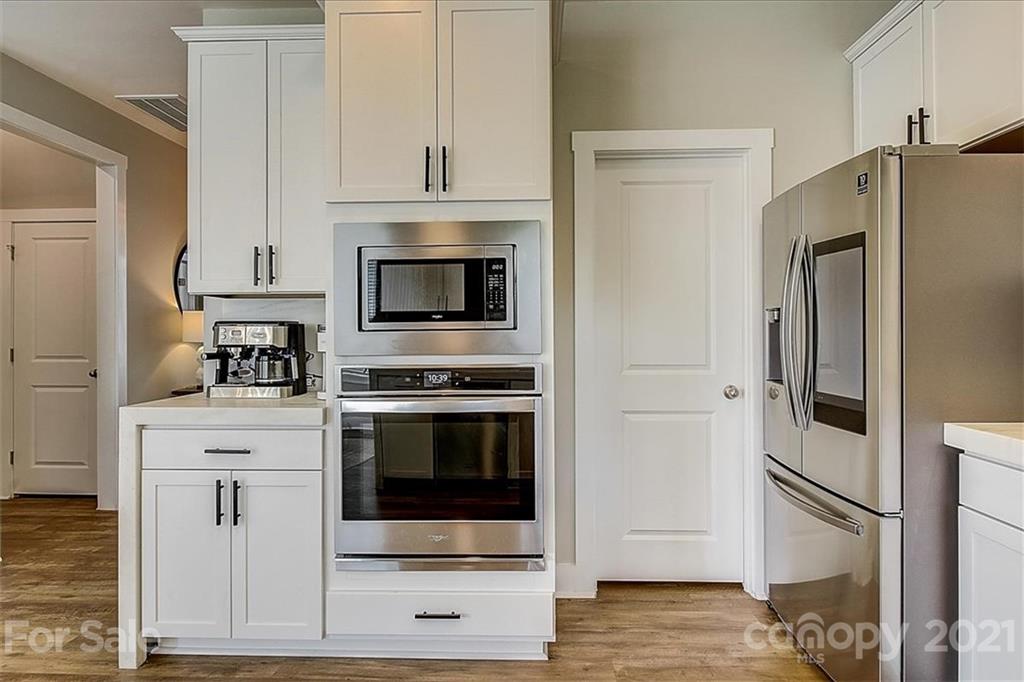1217 Therns Ferry Drive Fort Mill, SC 29708 - Photo 19 of 47 a kitchen with white cabinets and stainless steel appliances