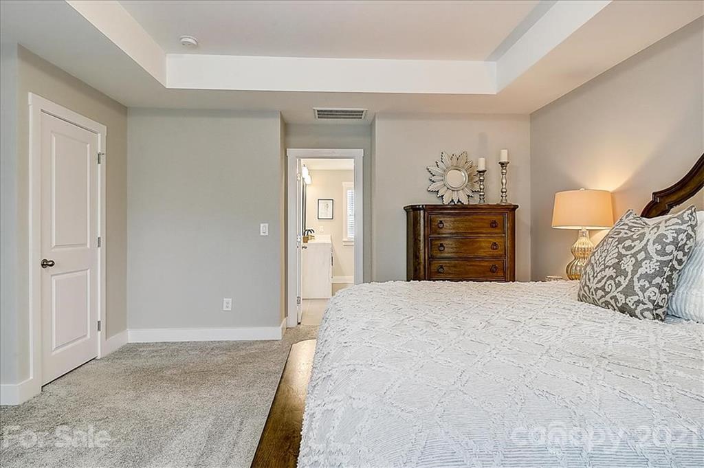 1217 Therns Ferry Drive Fort Mill, SC 29708 - Photo 29 of 47 a bedroom with a bed and wooden cabinets