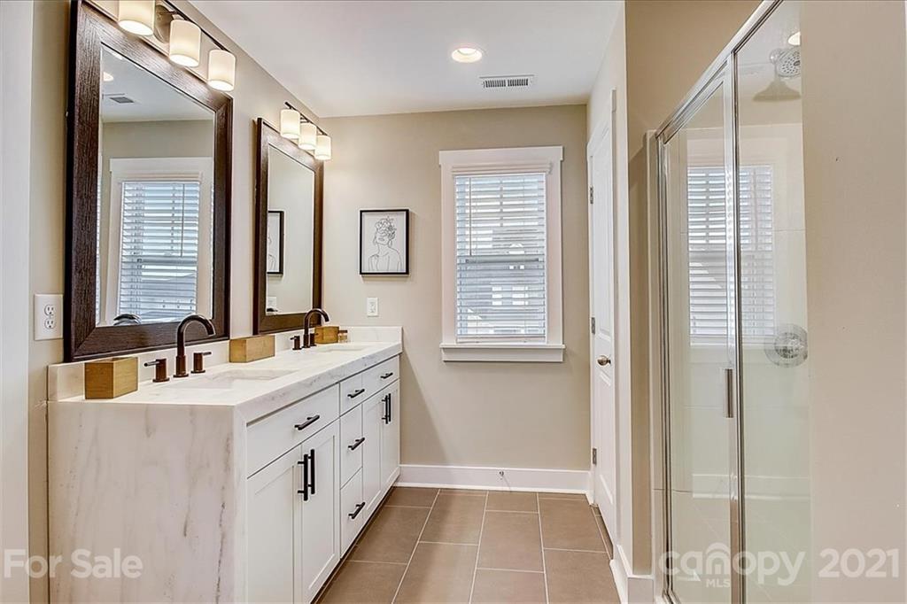 1217 Therns Ferry Drive Fort Mill, SC 29708 - Photo 30 of 47 a bathroom with a double vanity sink a mirror and a bathtub