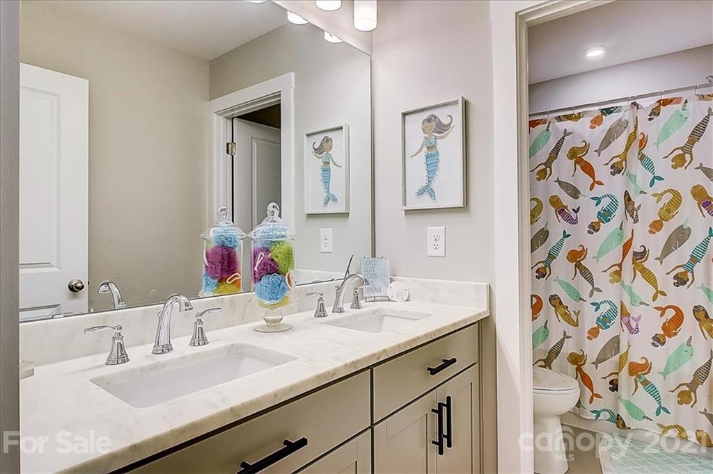 1217 Therns Ferry Drive Fort Mill, SC 29708 - Photo 36 of 47 a bathroom with double vanity sinks a mirror and a shower