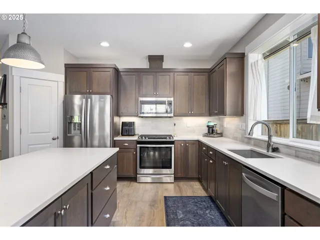 a kitchen with a sink stove and refrigerator