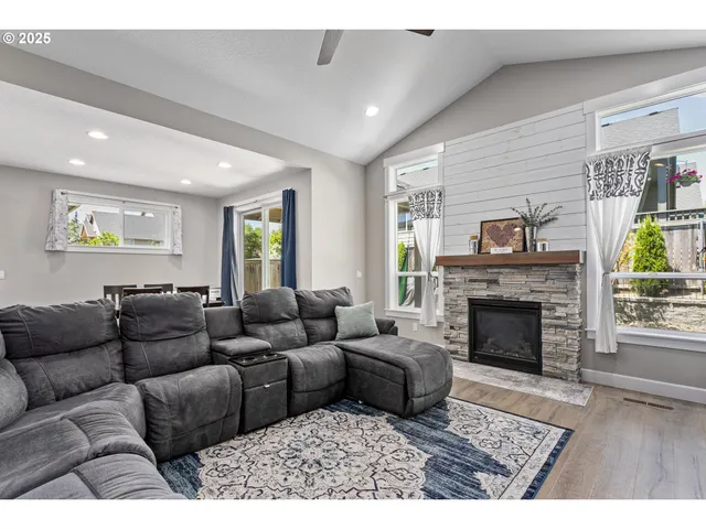 a living room with furniture and a fireplace