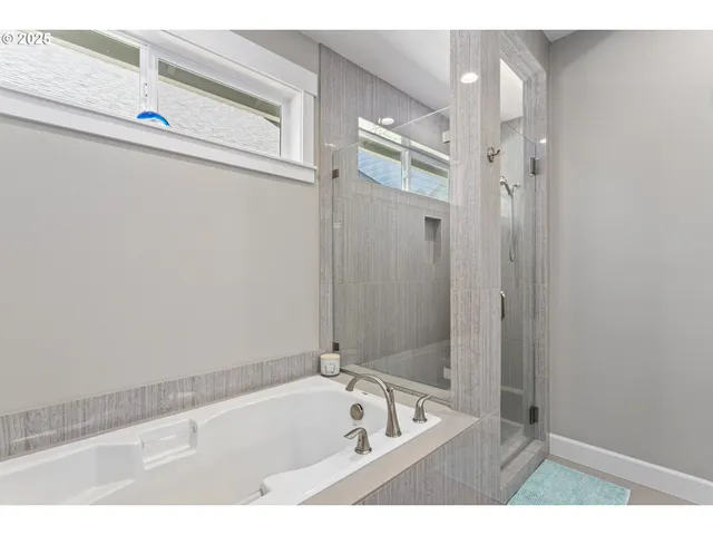 a bathroom with a bathtub and a shower