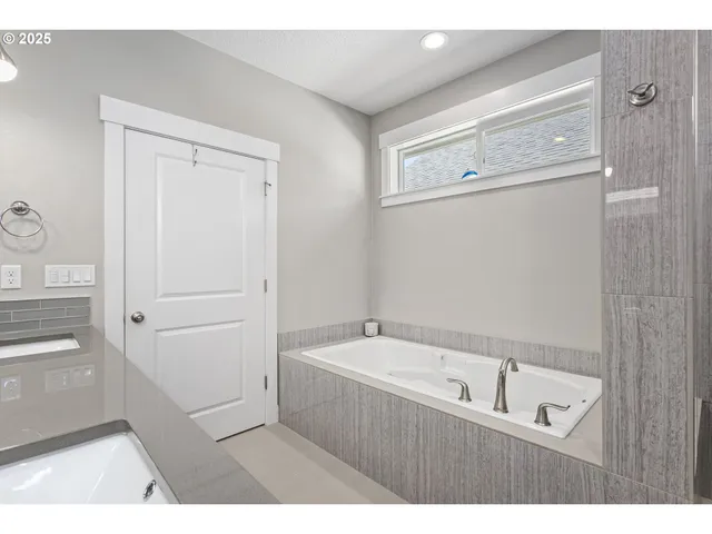 a bathroom with a bathtub and a shower