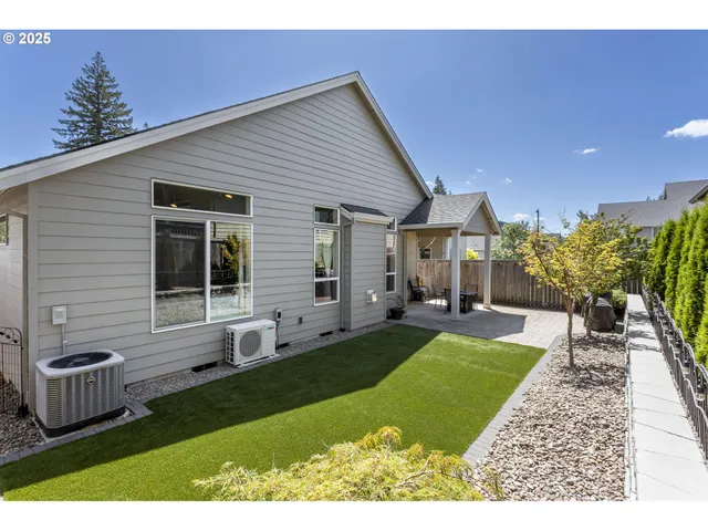 a view of a house with backyard porch and sitting area