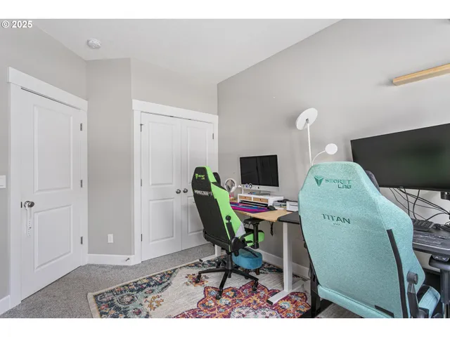 a view of a workspace with furniture and a flat screen tv
