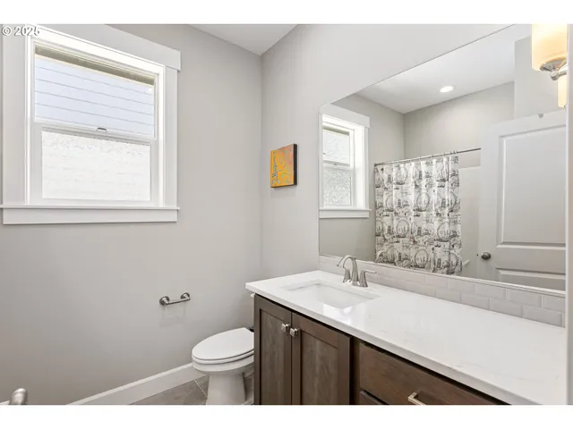 a bathroom with a sink a toilet and window