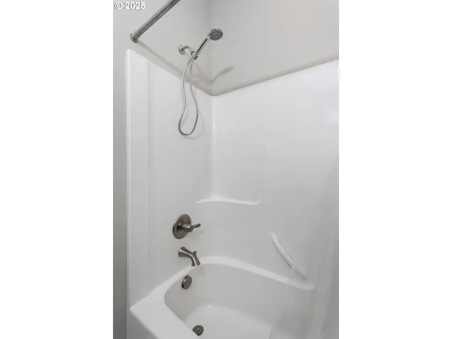 a bathroom with a tub and a sink