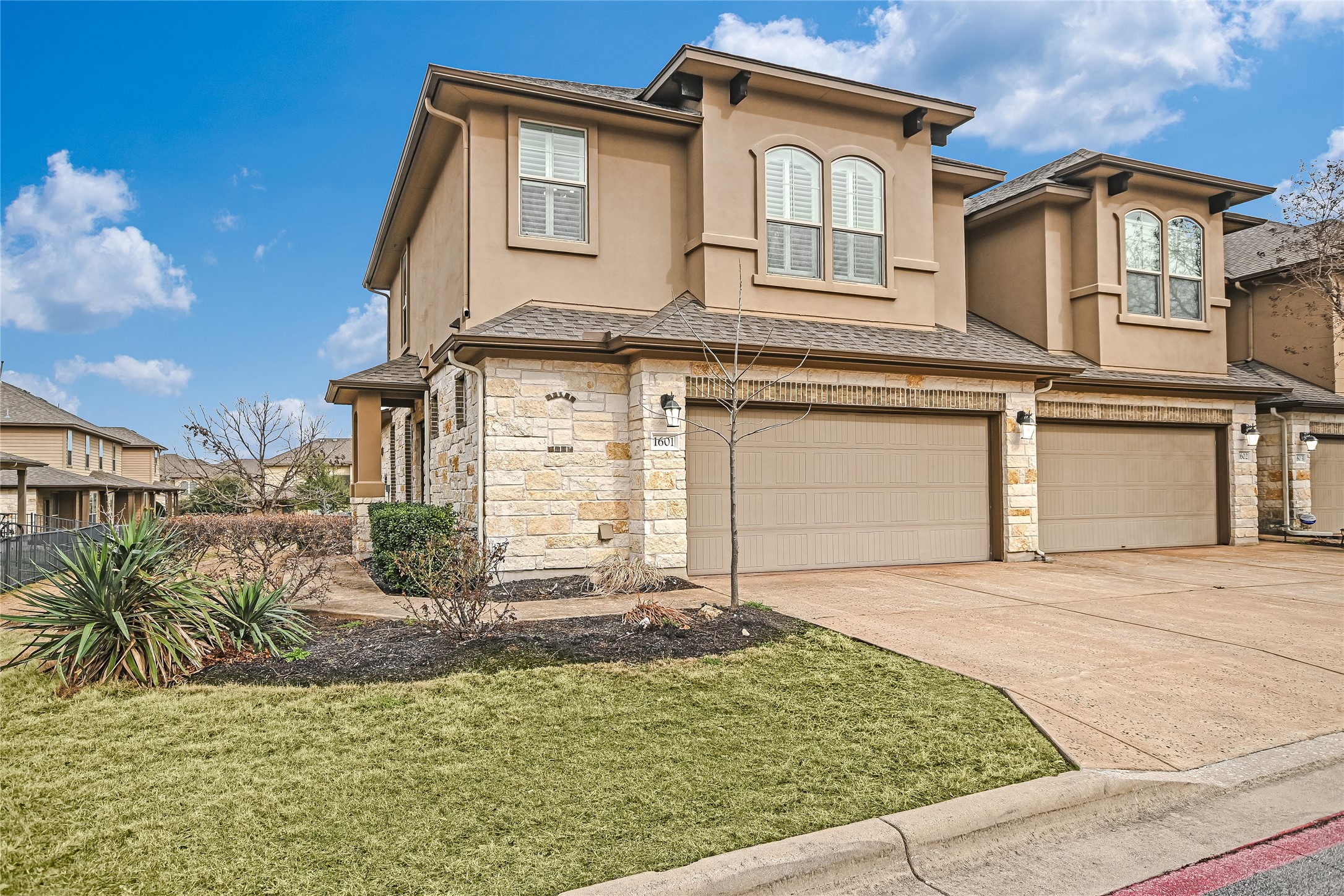 14001 Avery Ranch Boulevard, Unit 1601 Austin, TX 78717 - Photo 2 of 25 Mediterranean / spanish-style home with stone siding, stucco siding, an attached garage, and concrete driveway