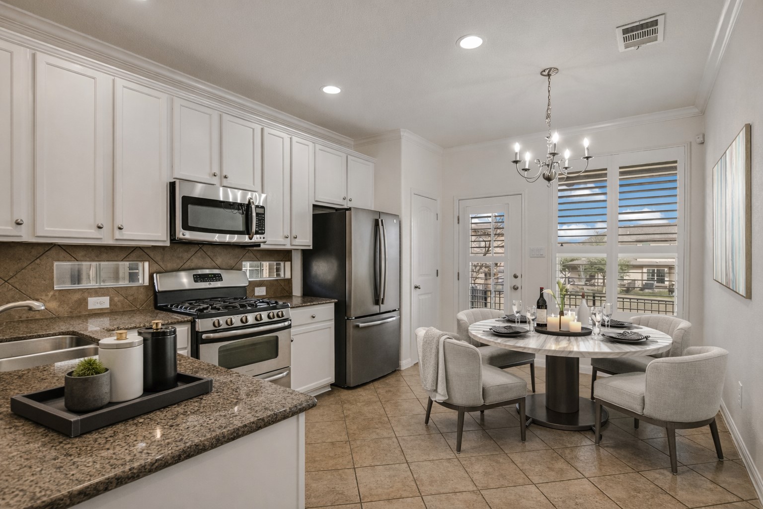 14001 Avery Ranch Boulevard, Unit 1601 Austin, TX 78717 - Photo 6 of 25 ~Virtually Staged: Kitchen featuring stainless steel appliances, white cabinetry, dark stone counters, crown molding, and decorative backsplash