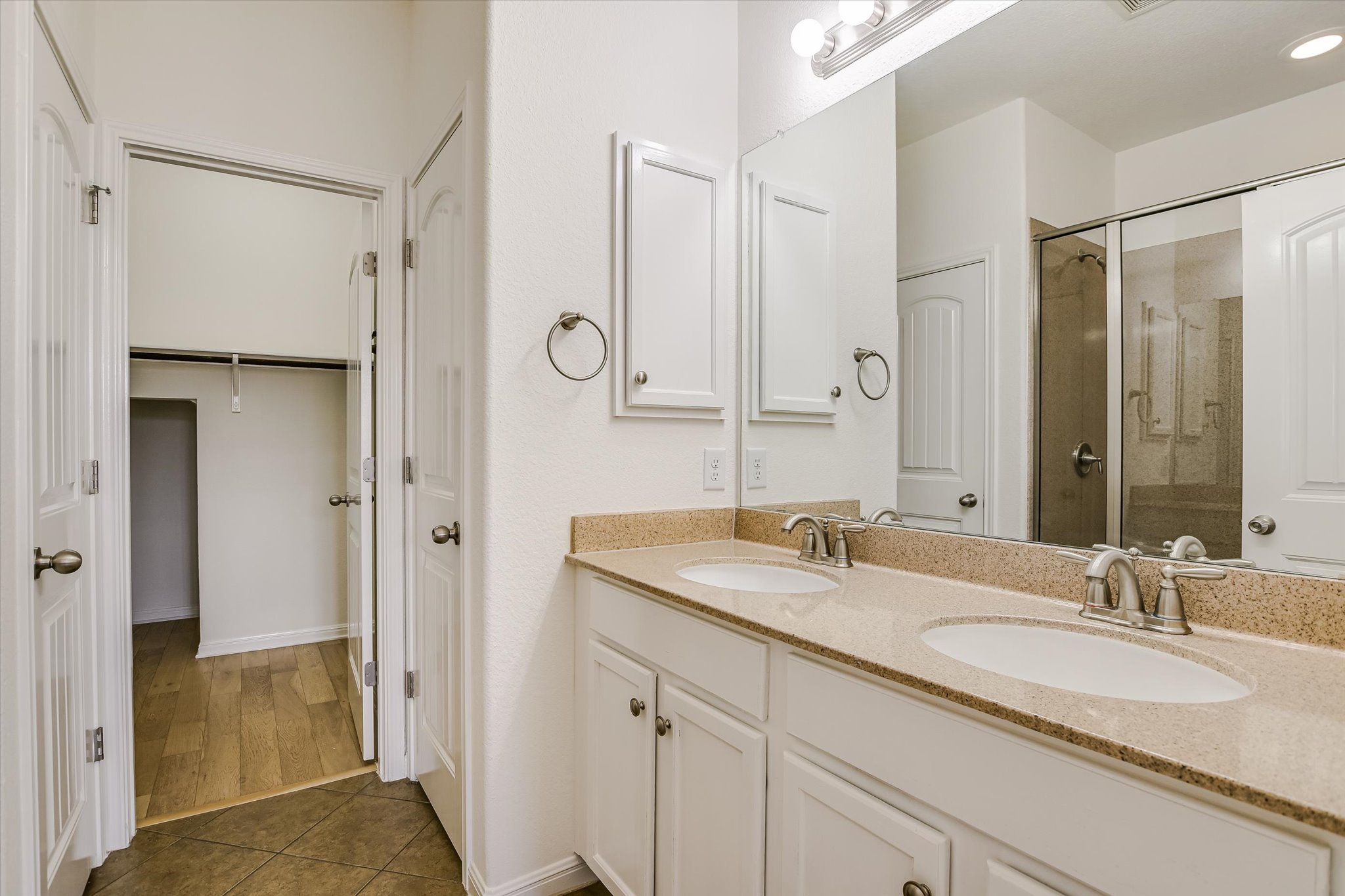 14001 Avery Ranch Boulevard, Unit 1601 Austin, TX 78717 - Photo 8 of 25 Primary Bathroom with a shower stall, double vanity, dark tile patterned floors, and a spacious closets