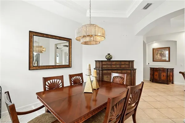 a dining room with furniture and a floor to ceiling window