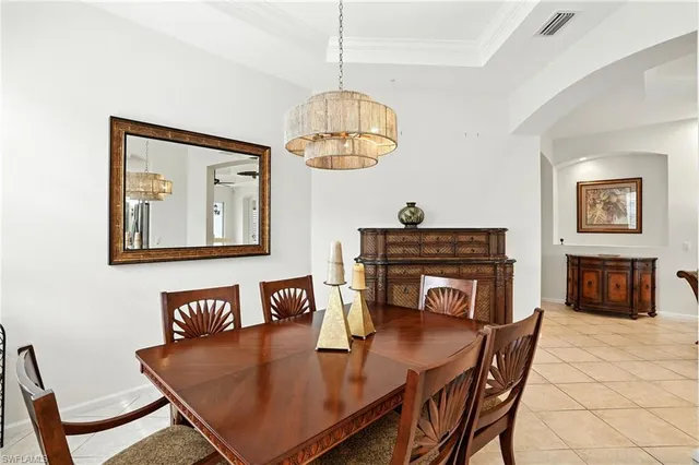 a dining room with furniture and a floor to ceiling window