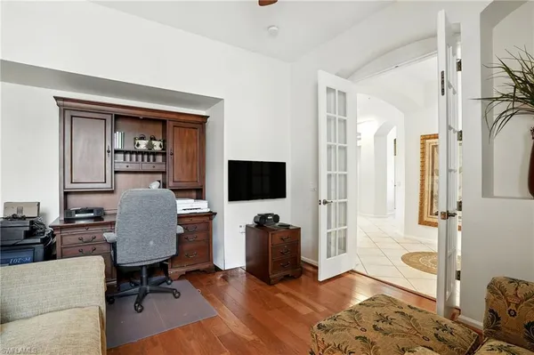 a bedroom with a bed and a television