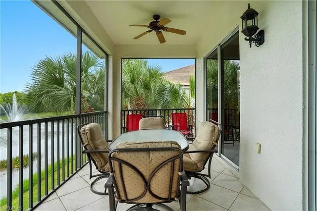 a bedroom with a bed a tv and wooden floor