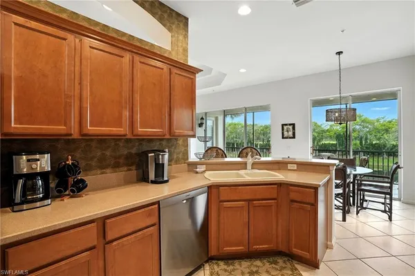 a kitchen with a sink stove top oven and cabinets