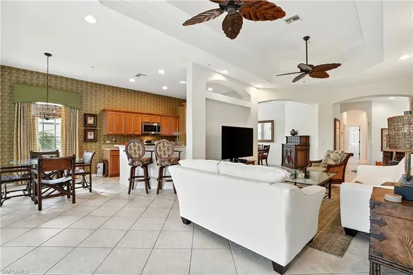 a living room with patio furniture and a flat screen tv