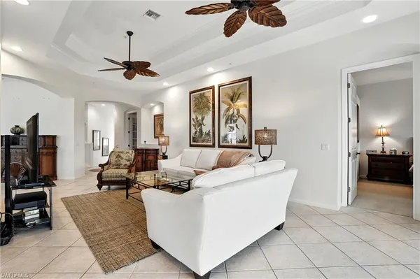 a view of a dining room with furniture a chandelier and wooden floor
