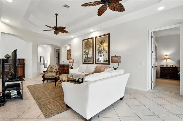 a view of a dining room with furniture a chandelier and wooden floor