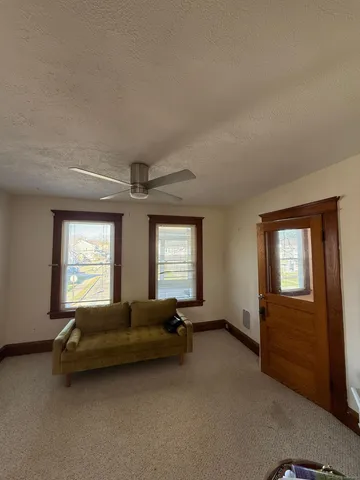 a kitchen with a refrigerator stove and wooden floor