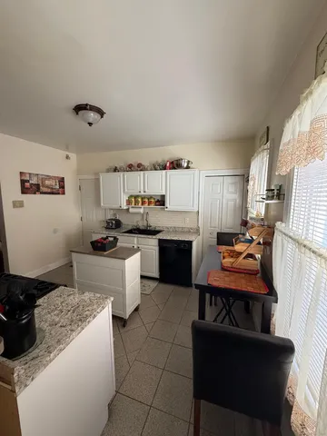 a bed room with a bed window and dresser