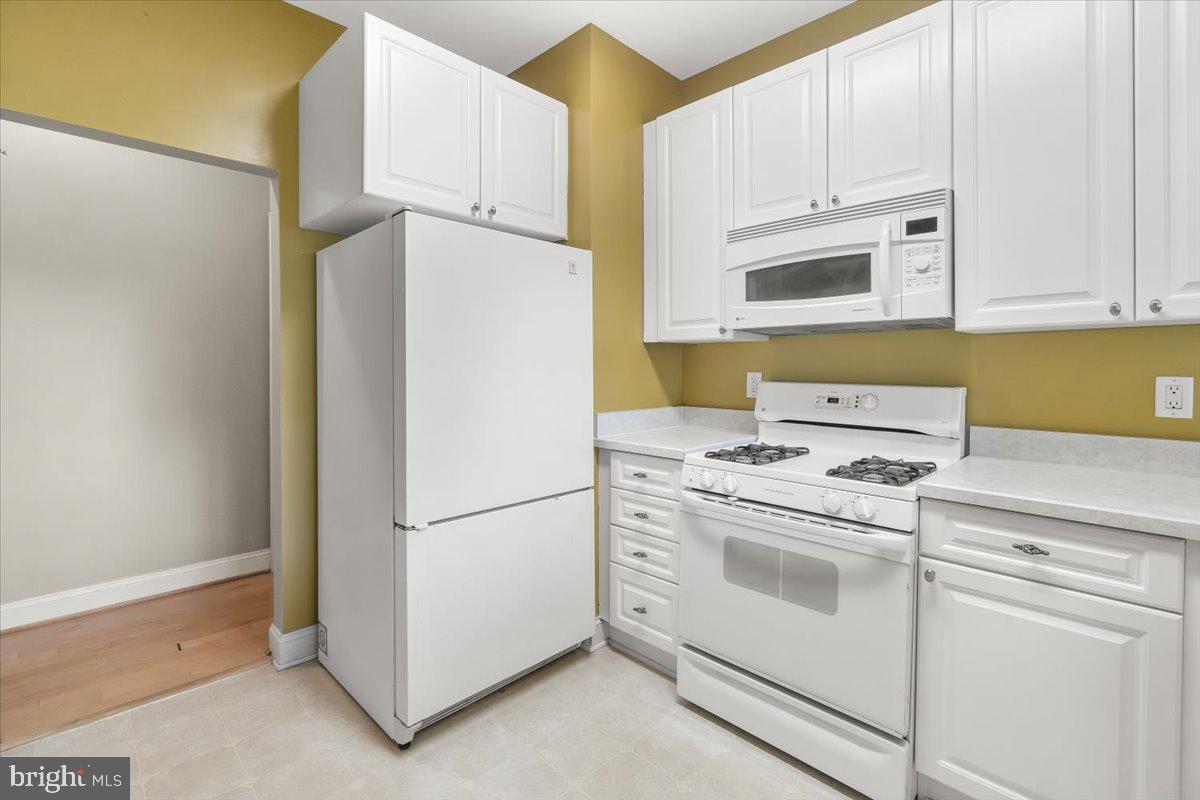 2500 Waterside Drive, Unit 306 Frederick, MD 21701 - Photo 20 of 50 a white refrigerator freezer and a stove sitting inside of a kitchen