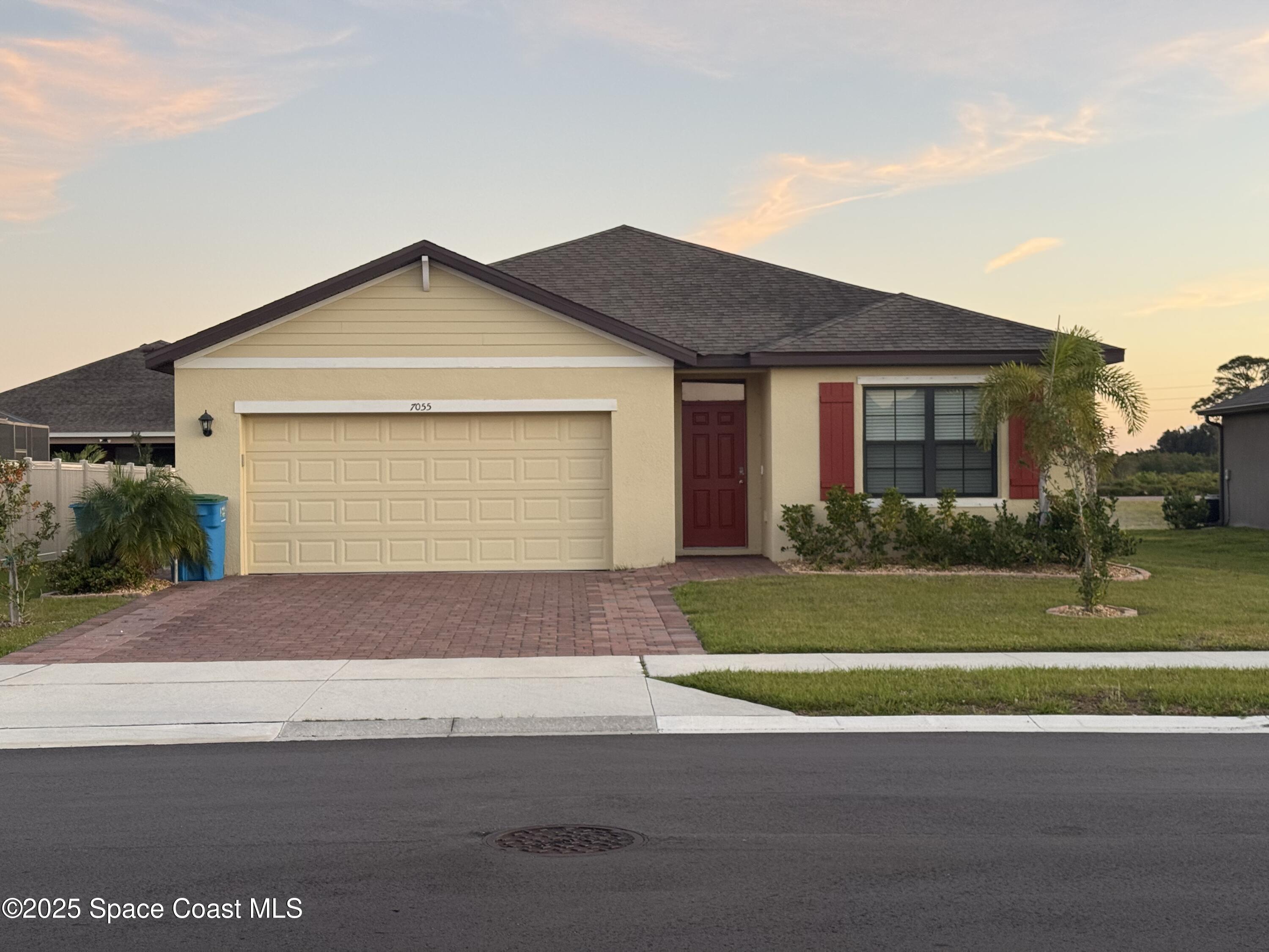 7055 Topaz Drive Grant-Valkaria, FL 32949 - Photo 1 of 24 a front view of a house with a yard