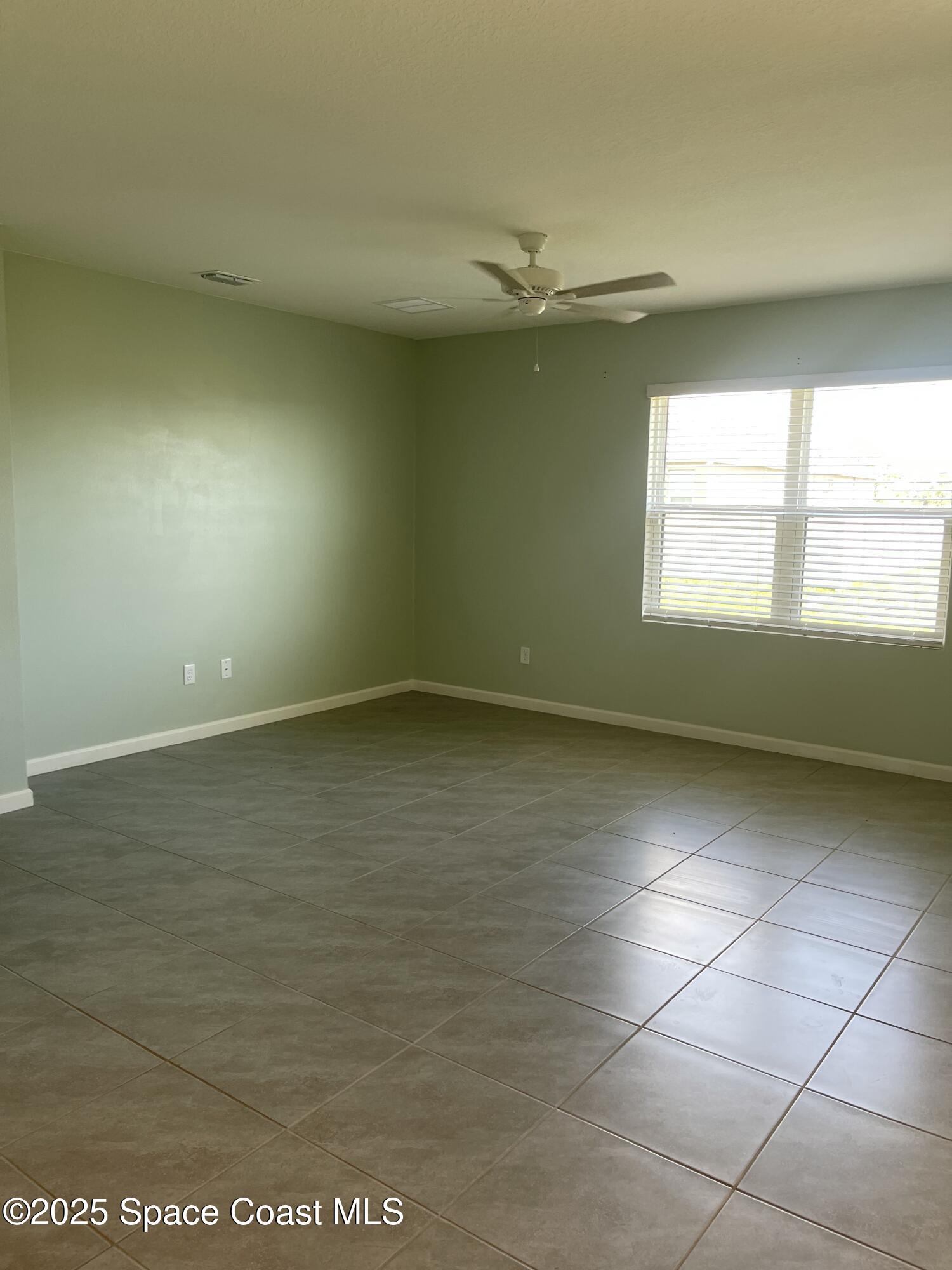 7055 Topaz Drive Grant-Valkaria, FL 32949 - Photo 11 of 24 an empty room with a empty space and windows