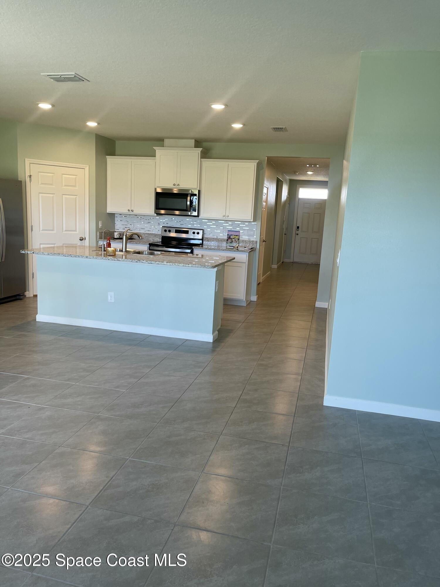 7055 Topaz Drive Grant-Valkaria, FL 32949 - Photo 13 of 24 a view of kitchen with refrigerator sink and stove