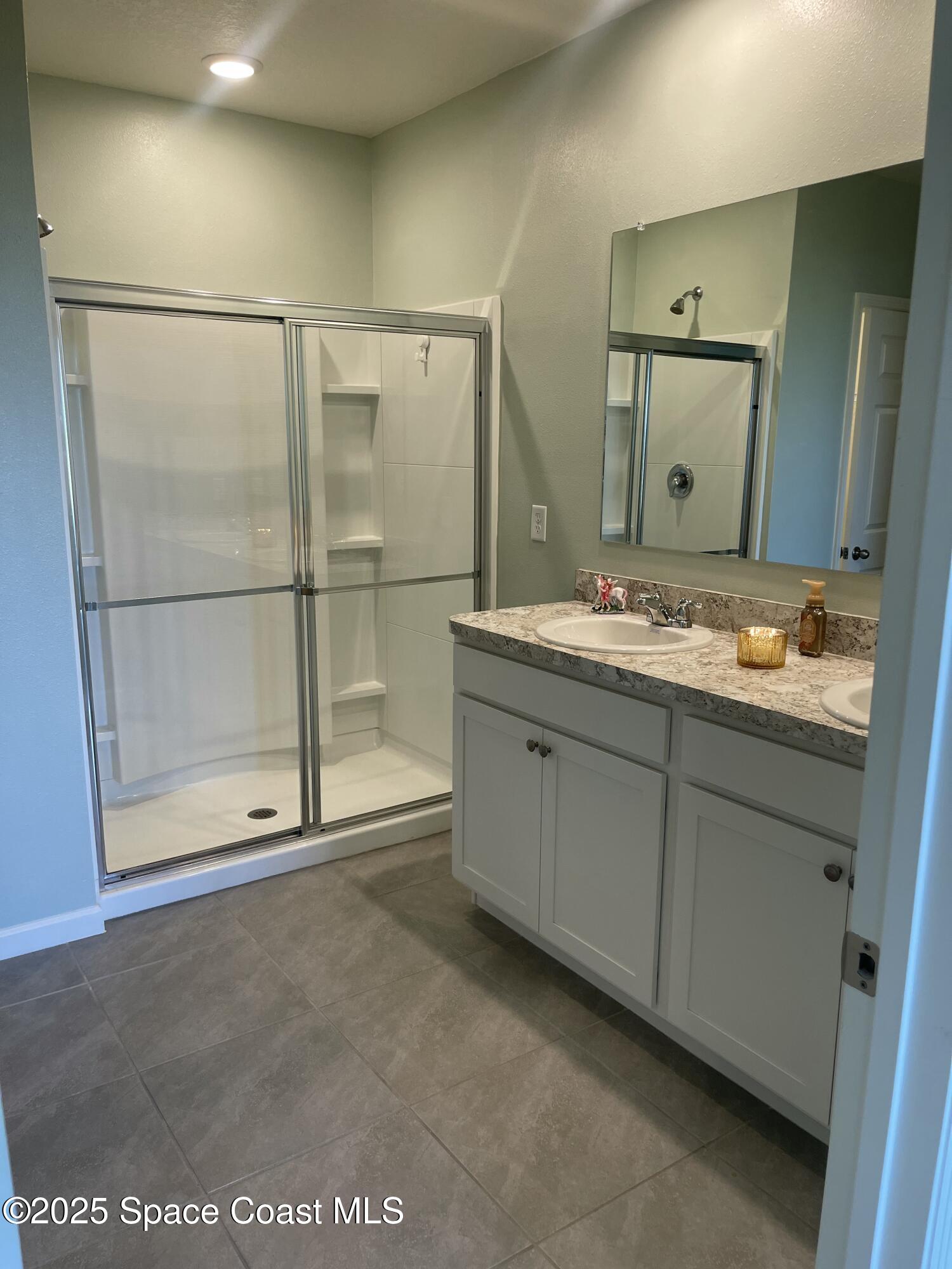 7055 Topaz Drive Grant-Valkaria, FL 32949 - Photo 16 of 24 a bathroom with a sink and a mirror