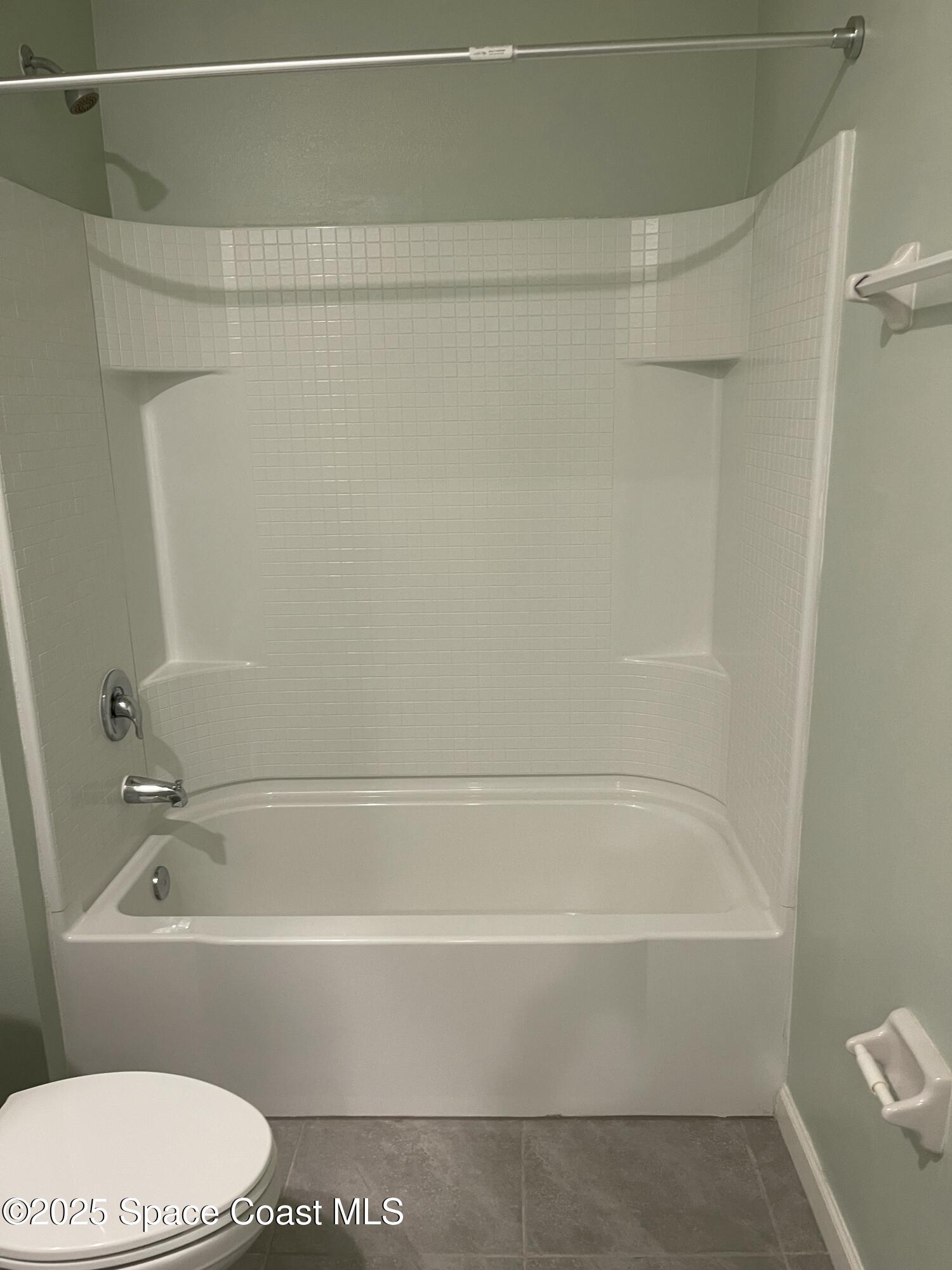 7055 Topaz Drive Grant-Valkaria, FL 32949 - Photo 17 of 24 a bathroom with a bathtub and a toilet