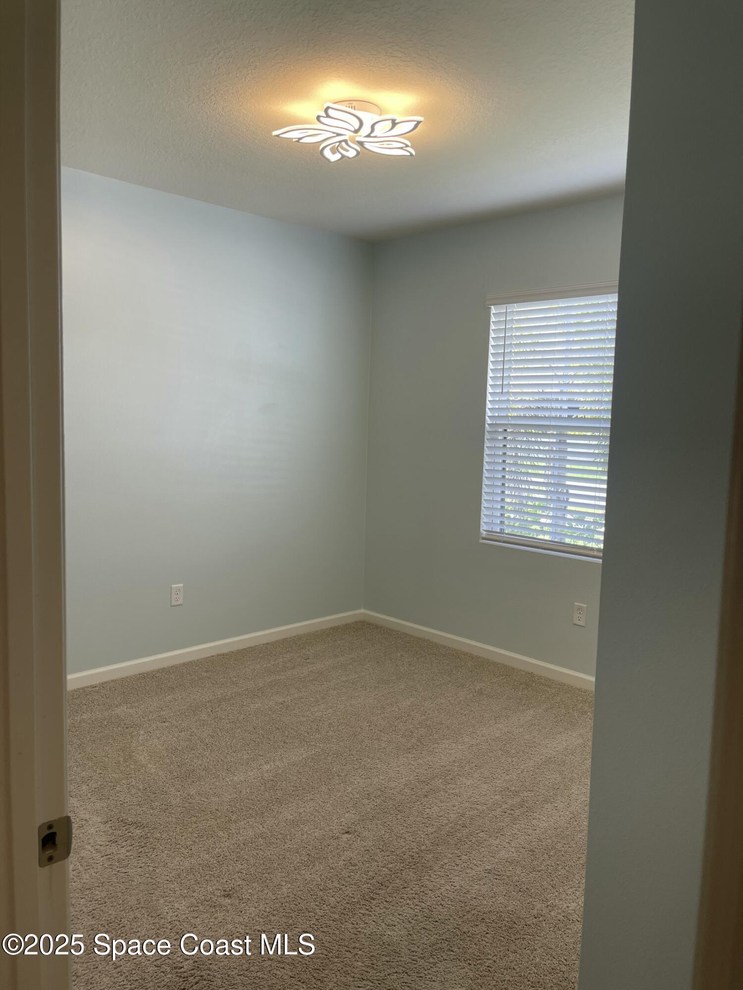 7055 Topaz Drive Grant-Valkaria, FL 32949 - Photo 18 of 24 an empty room with a window