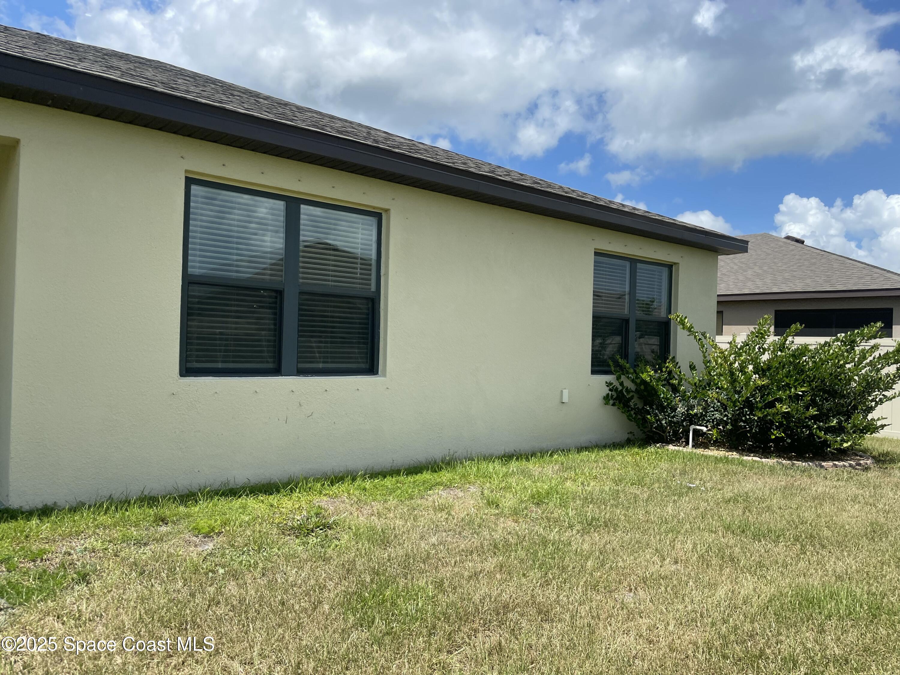 7055 Topaz Drive Grant-Valkaria, FL 32949 - Photo 21 of 24 a front view of a house