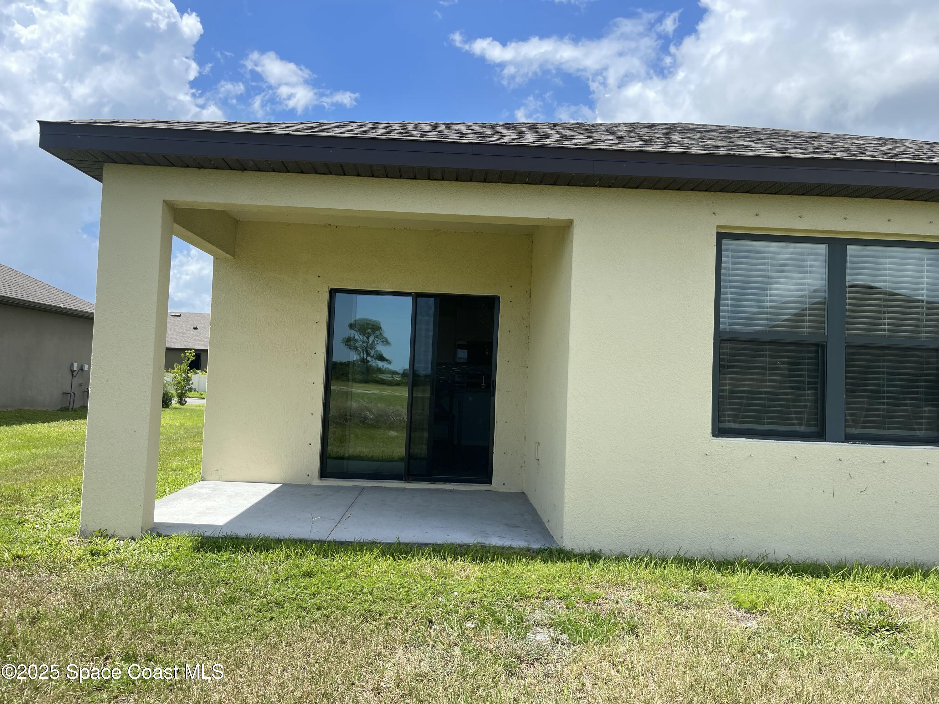 7055 Topaz Drive Grant-Valkaria, FL 32949 - Photo 23 of 24 a view of a house with backyard and tub
